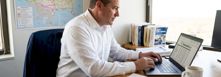 Fleet manager reviews trucking policies in office