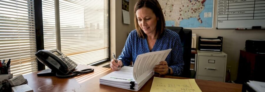 Fleet manager reviews trucking insurance paperwork