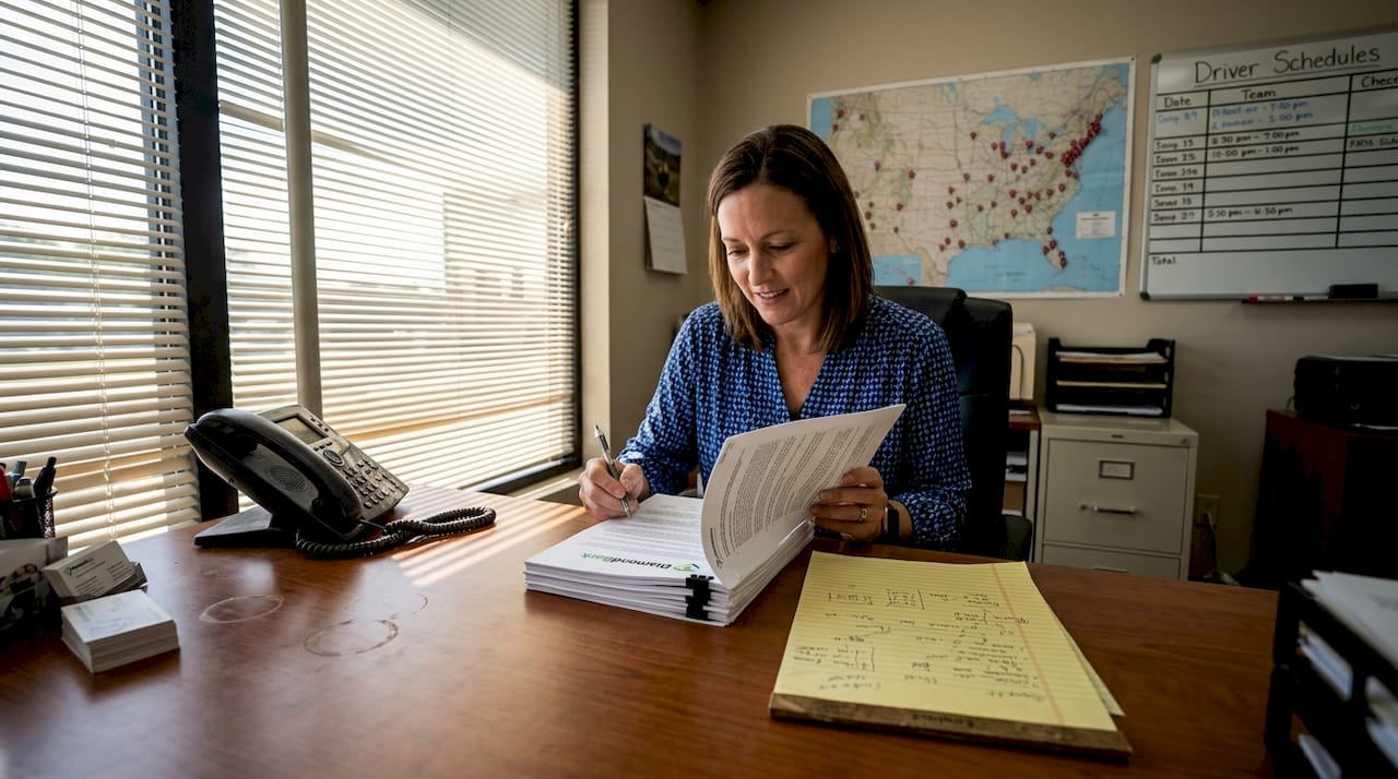 Fleet manager reviews trucking insurance paperwork