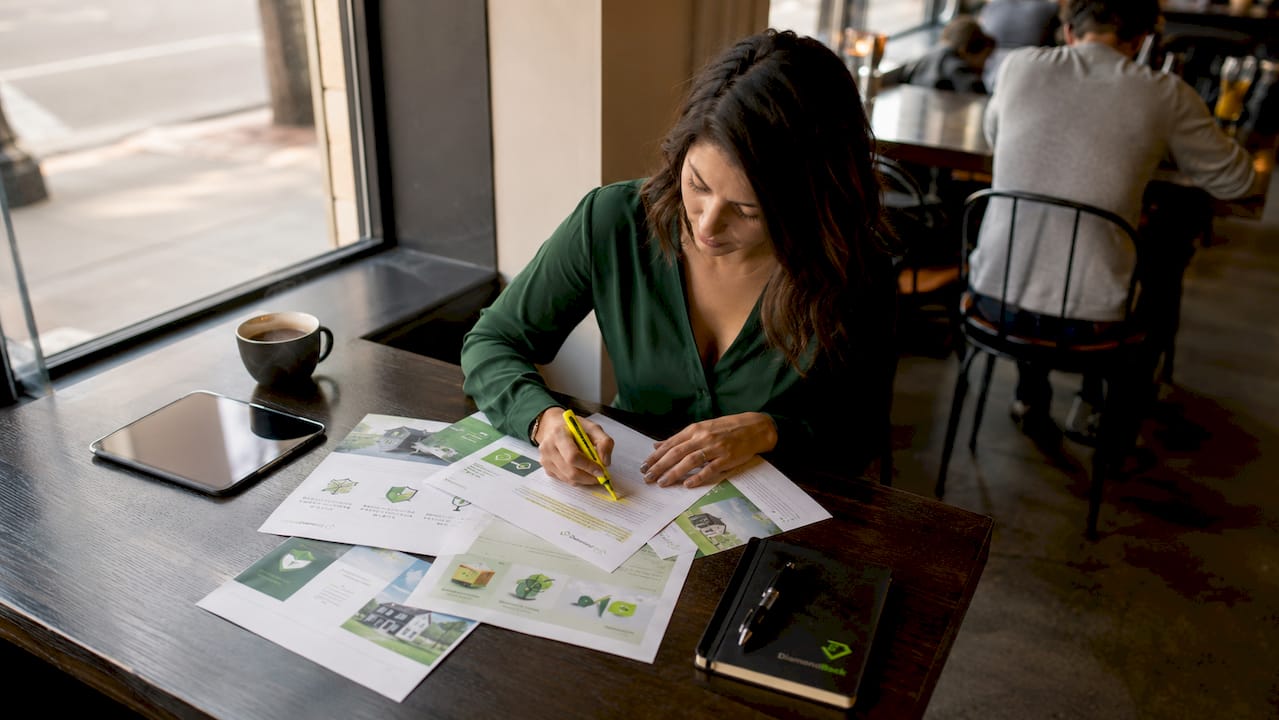 Woman comparing printed insurance policies