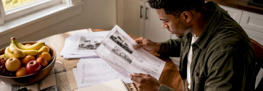 Man reviewing trucking insurance documents at desk