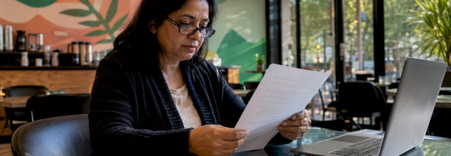 Woman reviewing insurance policy documents at home
