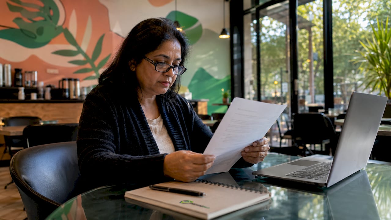 Woman reviewing insurance policy documents at home