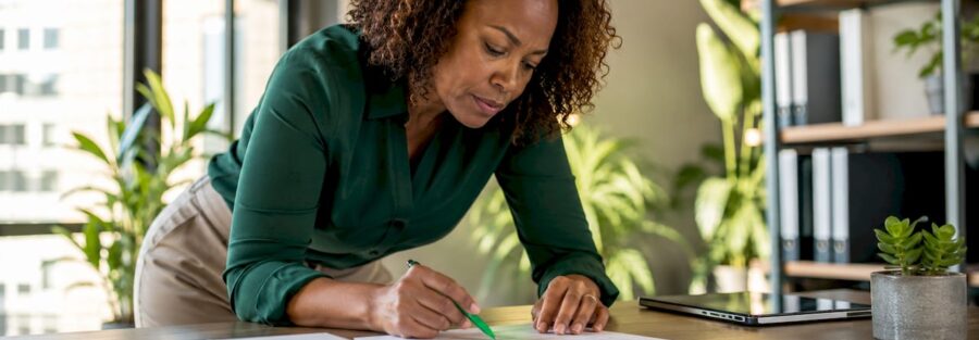 Woman reviewing insurance policy documents at home