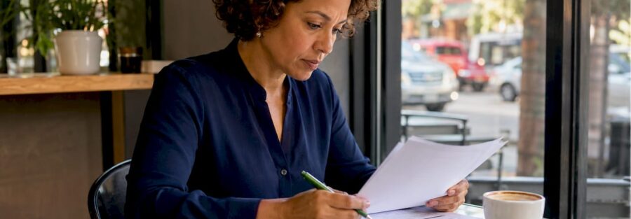 Businesswoman reviewing fleet insurance documents in office