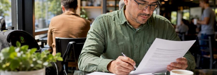 Man reviewing trucking insurance policy at desk