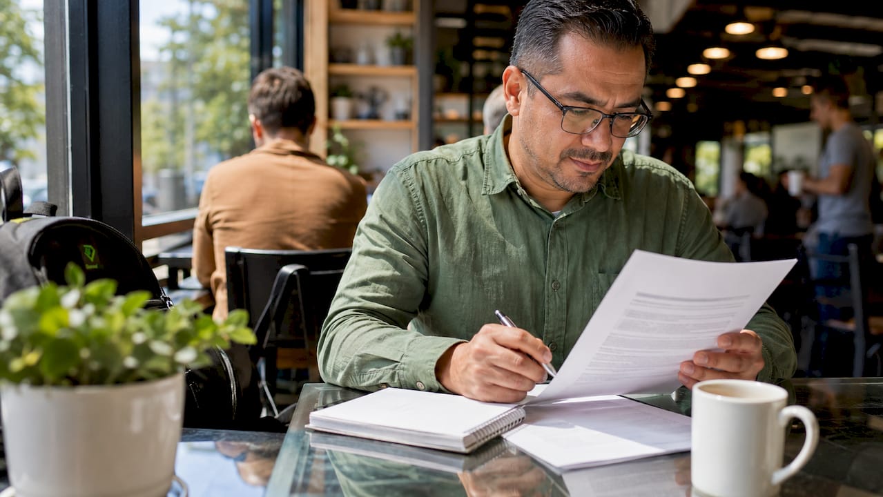Man reviewing trucking insurance policy at desk