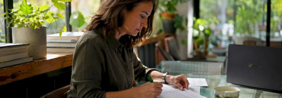 Insurance underwriter reviewing applications at desk