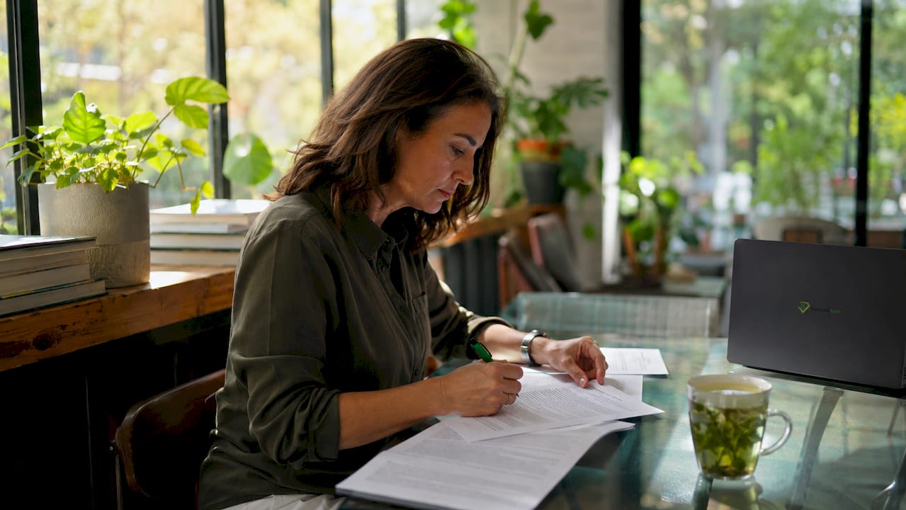 Insurance underwriter reviewing applications at desk