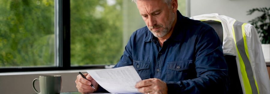 Trucking businessman reviewing insurance documents