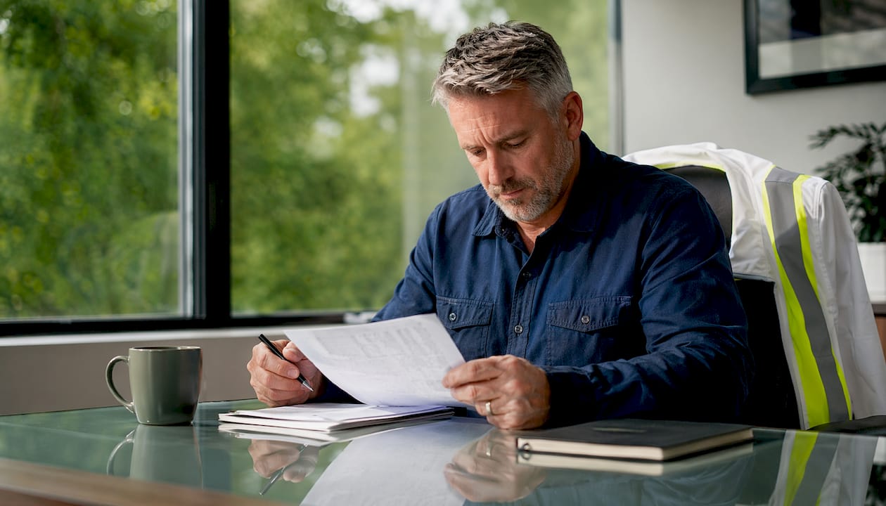 Trucking businessman reviewing insurance documents