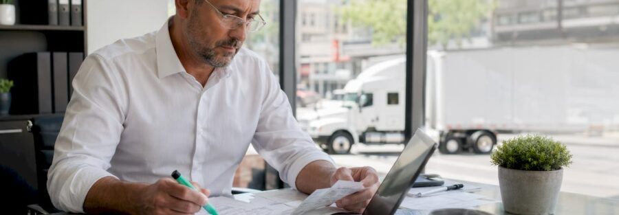Owner-operator reviewing trucking tax documents