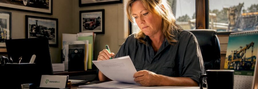 Tow truck operator reviewing insurance documents