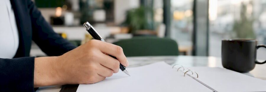 Close-up of hand holding insurance binder document