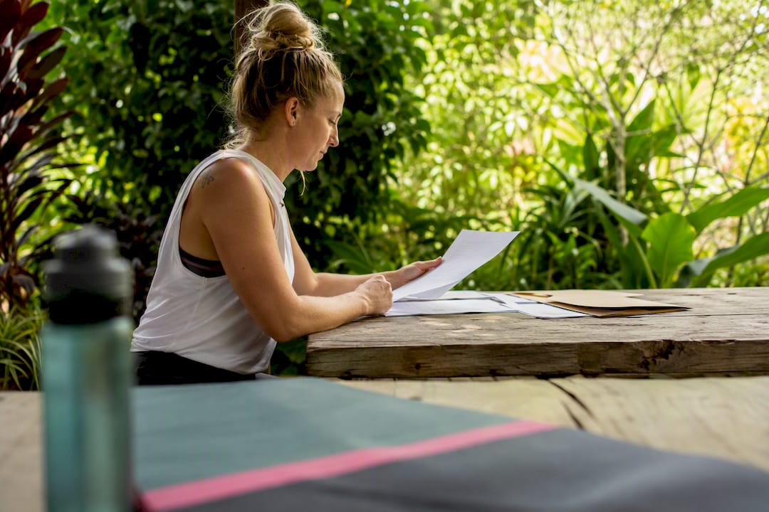 Fitness instructor filling insurance forms at desk