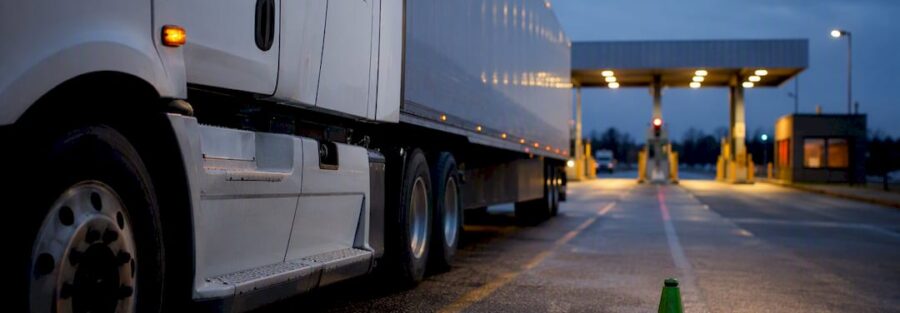 Anonymous truck entering weigh station at dusk