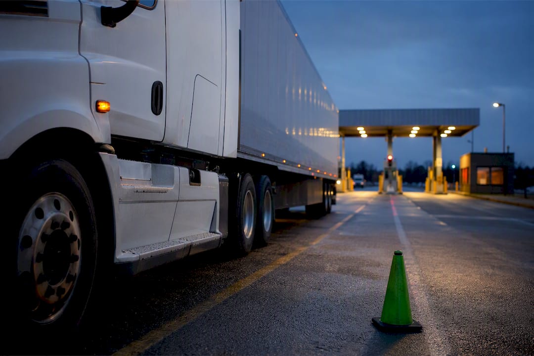 Anonymous truck entering weigh station at dusk